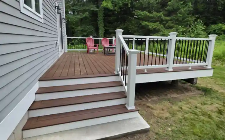 Brown composite deck with wide stairs and white risers