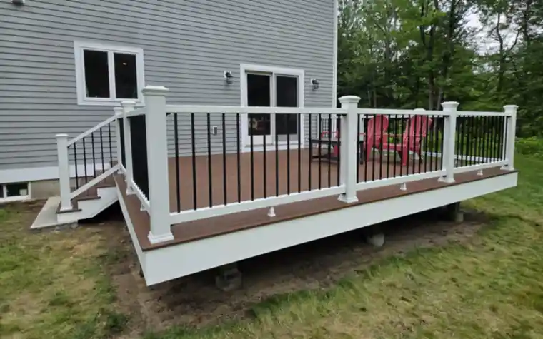Brown composite deck with white railing and black balusters