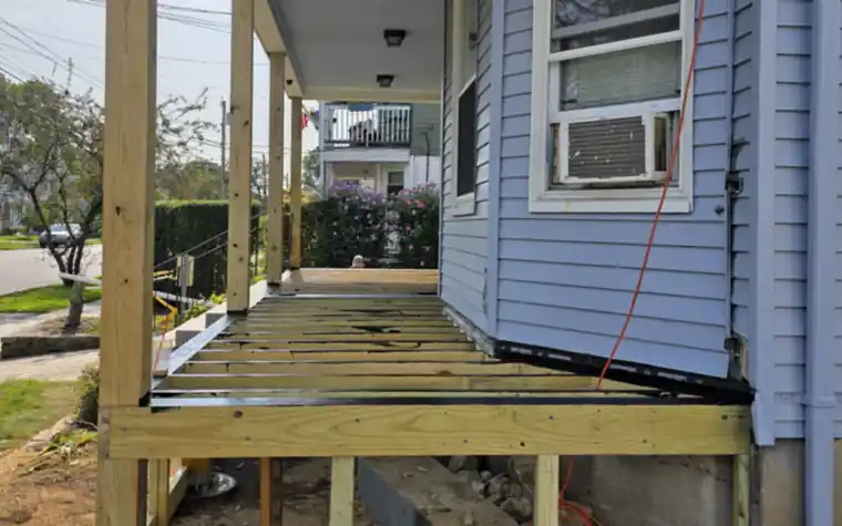 Front porch rebuild with new pressure-treated posts and framing