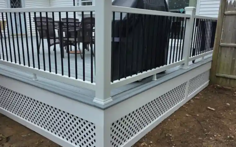 Gray composite deck with white railing and lattice skirting